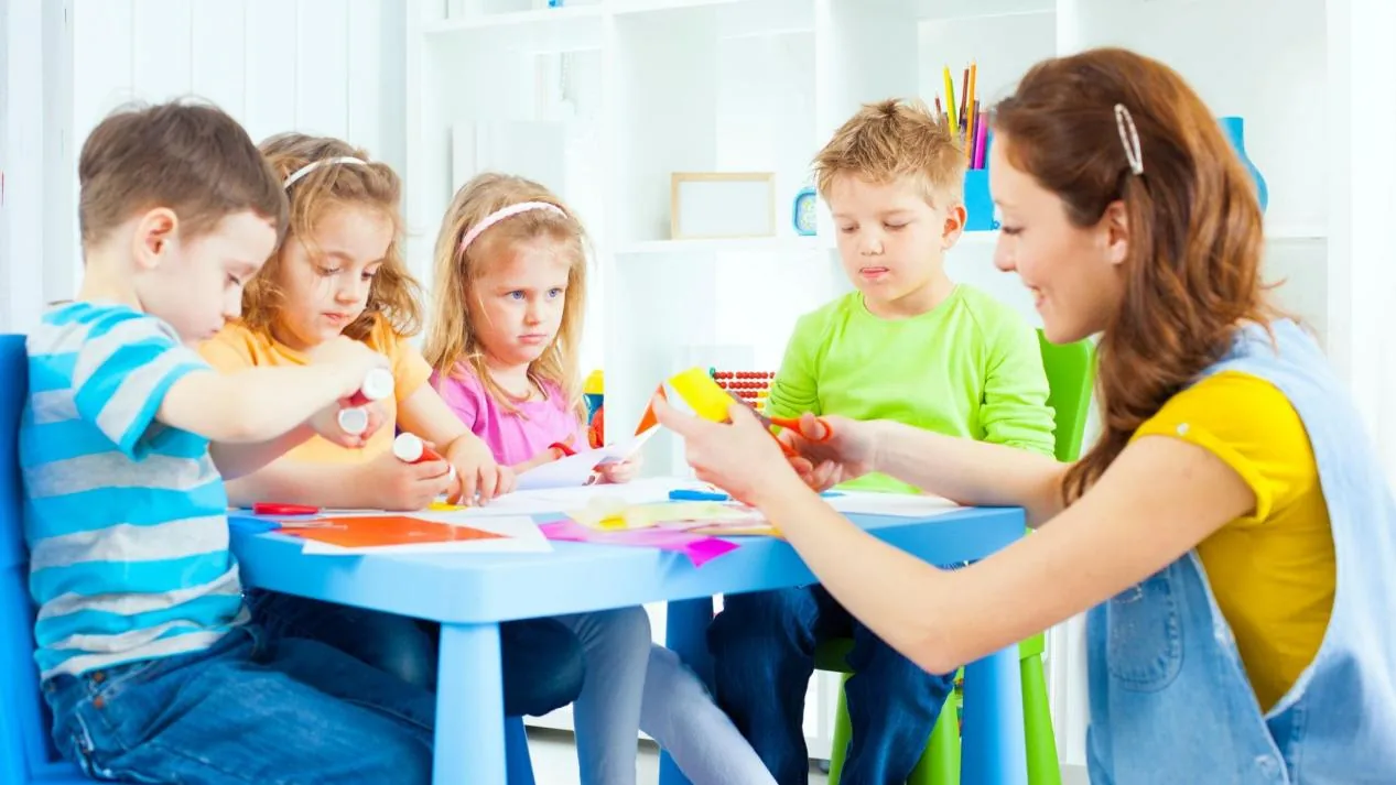 Children using non-toxic craft glue at school art workshop