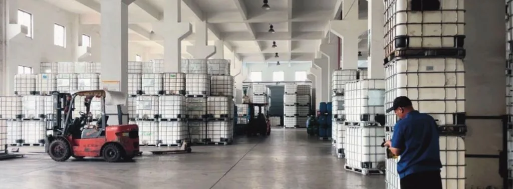 Desay factory warehouse — forklift handling IBC totes of industrial adhesives